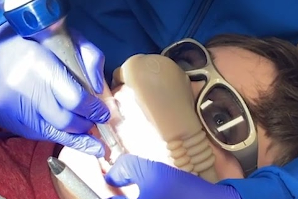 Dentist performing dental procedure