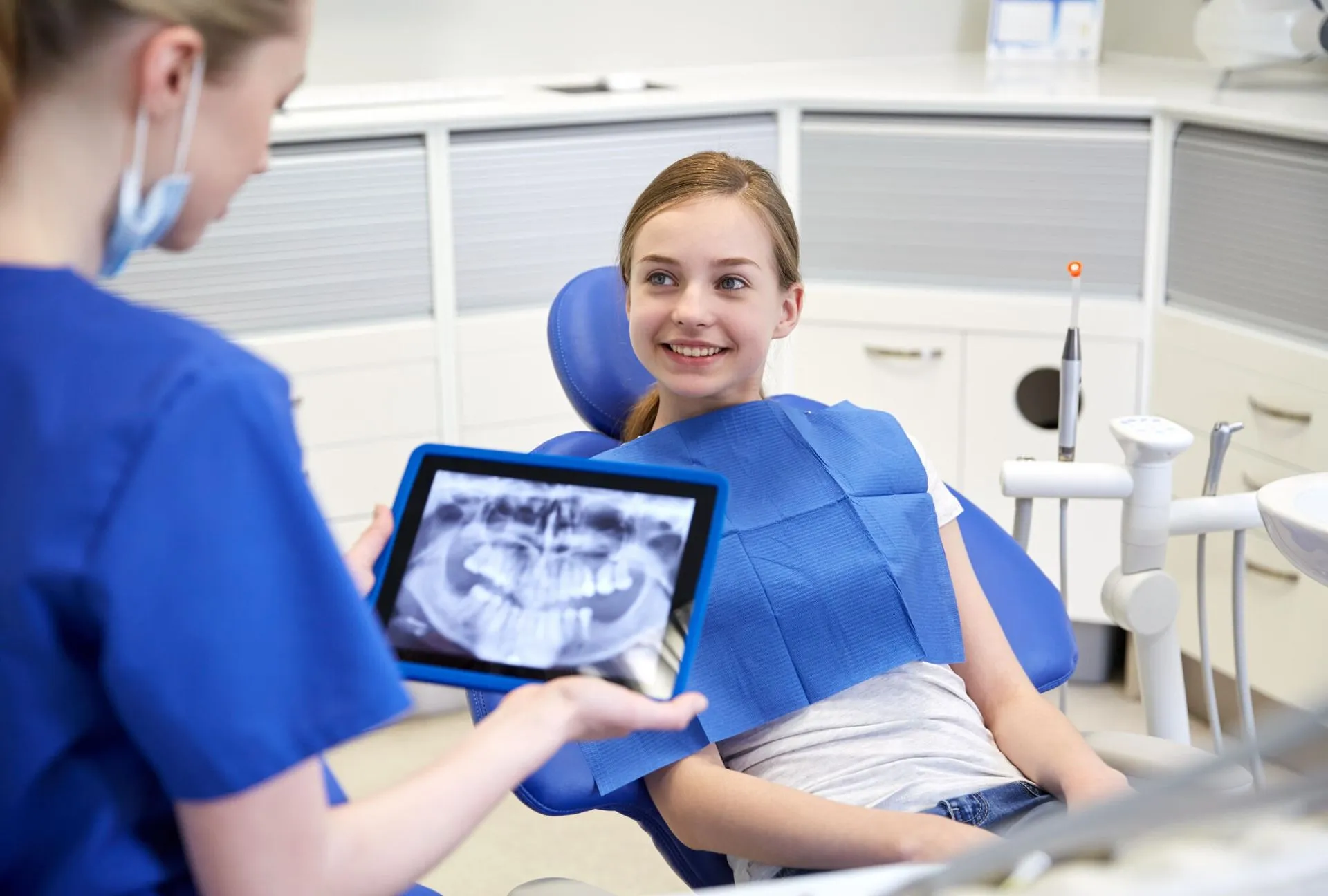 Teenager is smiling in a dental chair